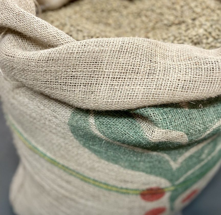 Green coffee beans in a jute sack